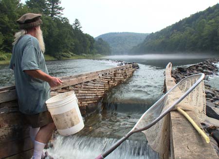 Hancock, NY: Ray admires the river from inside his weir. (Photo Credit: National Geographic Channels/ Ben Trueheart)